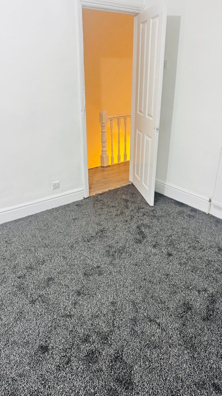 Charcoal flecked carpet fitted in a bedroom
