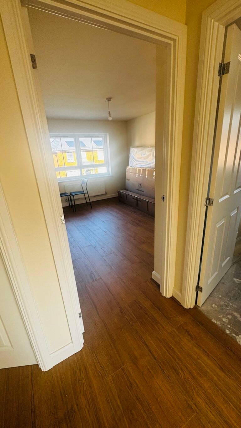 Dark oak laminate fitted through a hallway and bedroom