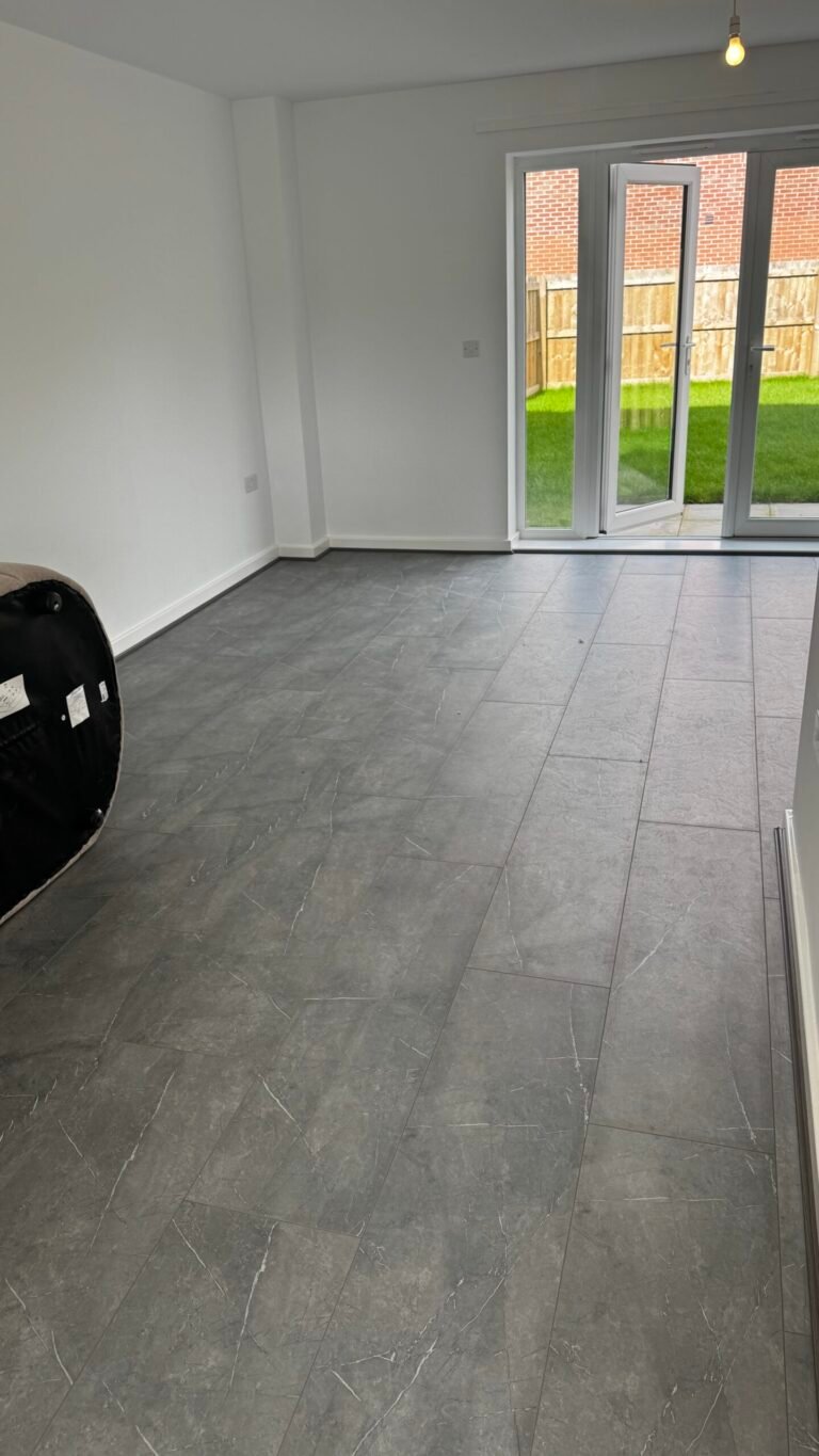 Grey stone-effect laminate fitted in an open-plan room with garden doors
