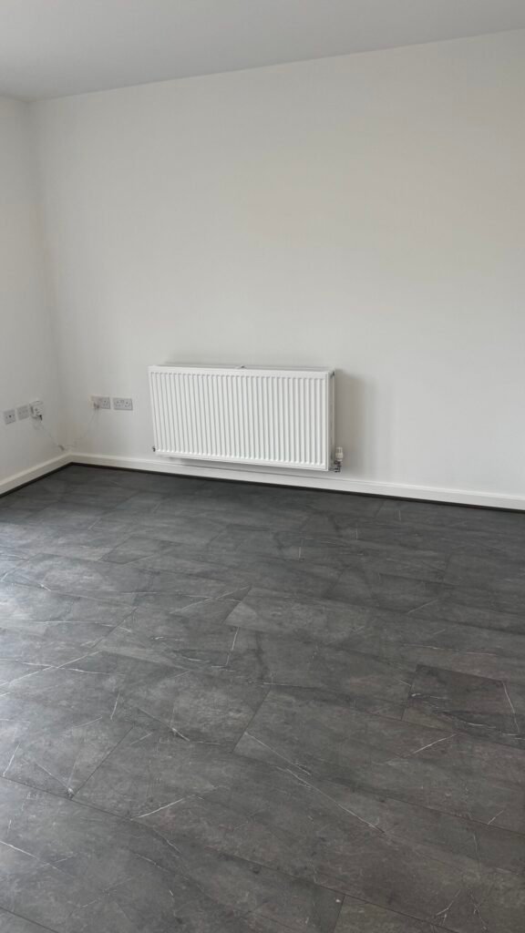 Grey stone-effect laminate fitted in a living room by Prime Carpets & Flooring